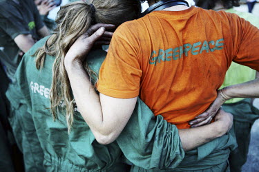 Greenpeace activists link arms at the end of an occupation of the Marghera coal power plant, part of a nationwide protest targeting four Italian coal power plants.