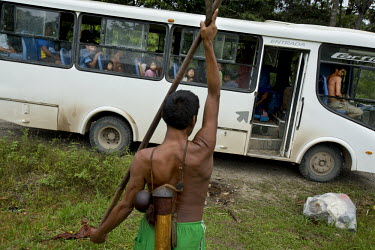Wemane Iteka, a Waorani (Huaroni) man, takes his blow pipe on the Maxus Road bus to a hunting spot along the road. He's the only one in the Guiyero area who still makes blow pipes. It takes him a few...
