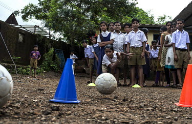 School children play games during a visit to their school in Majarli Village by a peer leader for Magic Bus, a children's eductaional NGO.