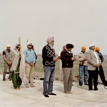 Sikhs pray at the site where the first Sikh temple in Georgia is to be built.