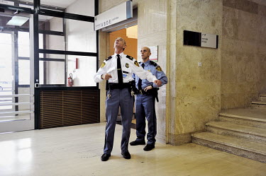 Two security guards await the arrival of delgates for the second round of the E3/EU+3 Iran talks at the Palais des Nations (UN). The E3 / EU + 3 talks, which include the UK, France and Germany plus th...