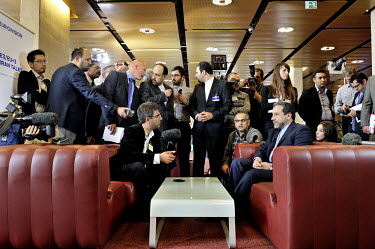 Iranian Foreign Ministry Spokesman Abbas Araqchi gives an interview with Iranian state TV in the press centre at the Palais des Nations (UN) with members of the international press crowding in at the...