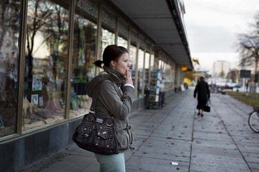 A young woman smokes a cigarette in front of a shop on the Lindenallee, the main street of Eisenhuettenstadt. The average age of the residents in the city has been rising steadily since German re-unif...