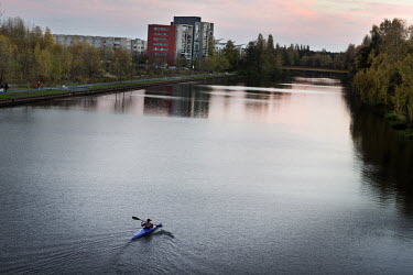 A man rows a kayak down the river Oder that flows through Eisenhuettenstadt. Founded in 1950 around a steel and given the name 'Stalinstadt' ('Stalin City') in 1953 in honour of the Soviet Leader Josp...