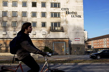 A young man on a bicycle passes the old Hotel Lunik at the end of Lindenallee, the city's main street. Named after the Soviet moon exploration programme, the hotel is now boarded up and dilapidated. F...