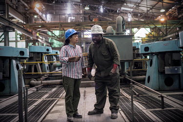 A Chinese operations manager in conversation with one of the Zambian staff at the NFCA's (Non-Ferrous Company Africa) Chambishi copper mine. Communication issues are blamed for many of the conflicts b...