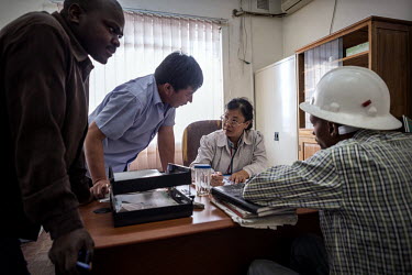 A Chinese operations managers in conversation with some of the Zambian staff at the NFCA's (Non-Ferrous Company Africa) Chambishi copper mine. Communication issues are blamed for many of the conflicts...