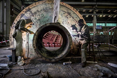 Welders at work in the NFCA's (Non-Ferrous Company Africa) Chambishi copper mine's maintenance workshop. The NFCA, a Chinese company, owns and operates several mines and plants in the Copperbelt. The...