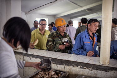 Chinese staff line up for lunch at the NFCA's (Non-Ferrous Company Africa) Chambishi copper mine. The NFCA, a Chinese company, owns and operates several mines and plants in the Copperbelt. The Chinese...