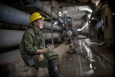 A Chinese supervisor in an underground pumping station at the NFCA's (Non-Ferrous Company Africa) Chambishi copper mine. All water is collected at this, the lowest point in the mine, before beinf pump...