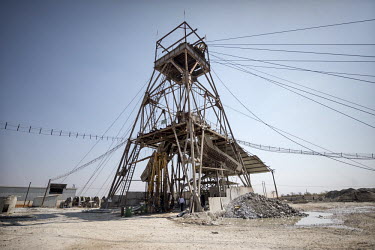The winding tower, standing over a shaft, with cables going to the hoist house where an operator controls the lift cage at the NFCA's (Non-Ferrous Company Africa) Chambishi copper mine. The NFCA, a Ch...