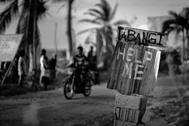 A sign which reads: 'Help Me' stands by the side of the road in Tinubdan. Typhoon Haiyan, or Typhoon Yolanda as it is known in the Philippines, was the deadliest typhoon to hit the Philippines to date...
