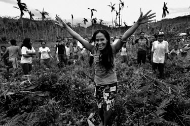 A woman cheers the arrival of relief goods brought in by a US Army helicopter to Mahagnau village on Leyte island. Many remote communities had to wait for days to receive help. Typhoon Haiyan, or Typh...