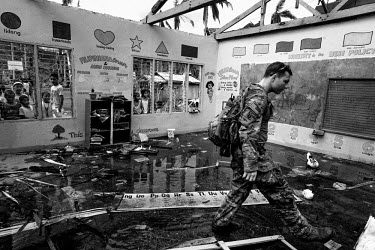 US Green Beret Captain Medfort walks through a school damaged in the typhoon. Typhoon Haiyan, or Typhoon Yolanda as it is known in the Philippines, was the deadliest typhoon to hit the Philippines to...
