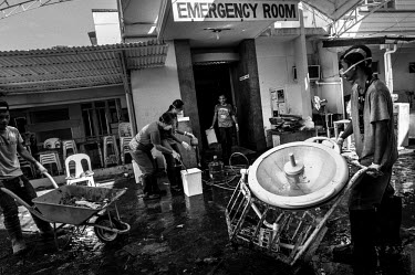 Staff at Tacloban Hospital help out in the clean up operation following Typhoon Haiyan. Much of the hospital was submerged in the storm surge. Typhoon Haiyan, or Typhoon Yolanda as it is known in the...