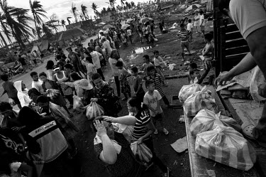 Relief supplies are distributed from the back of a truck in Taloban City. Typhoon Haiyan, or Typhoon Yolanda as it is known in the Philippines, was the deadliest typhoon to hit the Philippines to date...