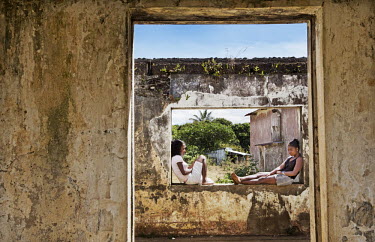 Two girls chatting in the ruins of an old school.