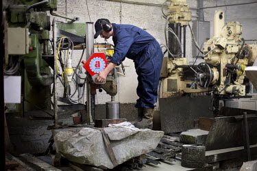 A curling stone, made from Ailsa Craig granite, being cut at Kay's in Mauchline, Faslane. The company uses the same rock to make the stones that will be used at the Sochi Olympic Games.