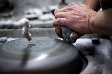 A curling stone, made from Ailsa Craig granite, being polished at Kay's in Mauchline, Faslane. The company uses the same rock to make the stones that will be used at the Sochi Olympic Games.