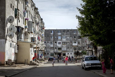People socialise in the street outside a residential housing block in the Roma district of Ferentari.