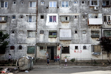 Women and children outside a residential housing block in the Roma district of Ferentari.