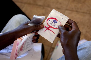 A participant in a training course holds packets of female condoms (femidoms) during a Capacity Building Training forum for Male Advocates, Peer Educators and Community Advocacy Groups (CAGS). The tra...
