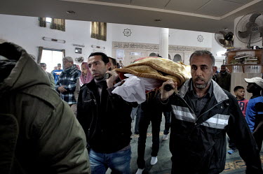 Men carry the body of Saleh Abu Latif  through a mosque in the Bedouin town of Rahat. Abu Latif, 22, a Bedouin worker, was killed by a Palestinian sniper while maintaining the Israeli-Gazan border fen...