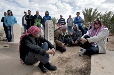 Bedouin men gather in the cemetery for the funeral of Saleh Abu Latif. The 22 year old Bedouin worker was killed by a Palestinian sniper while maintaining the Israeli-Gazan border fence.
