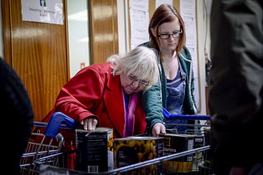 Janet Webster (left) with her granddaughter Elizabeth Sealey examine what is on offer at a food bank in Hull.