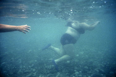 A woman swims in the Black Sea near Pitsunda.
