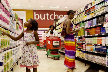 28 year old Perpetna Chetse Chiimba shopping in a SPAR supermarket, in the upmarket Sam-Levy's shopping complex, with her daughter Rutendo Chetse Chiimba, (7). Chetse Chiimba works in an estate agency...