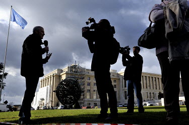 A journalist talking to camera in front of the Palais des Nations during the Geneva II Syria talks. The Geneva II talks being held in Montreux and Geneva between 22 and 24 January 2013 are bringing to...