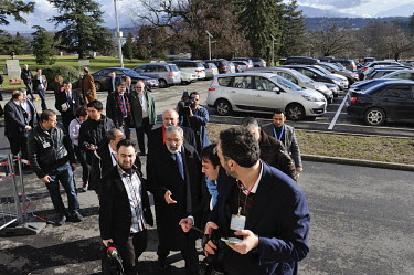 Syrian Minister of Information Omran al-Zoubi, with staff, being folllowed by the media in the park of the Palais des Nations during the Geneva II Syria talks. The Geneva II talks being held in Montre...