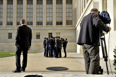 Louay Safi, Syrian Opposition Spokesman (middle, in a suit) talking to the internatinal media in front of the Palais des Nations during the Geneva II Syria talks. The Geneva II talks being held in Mon...
