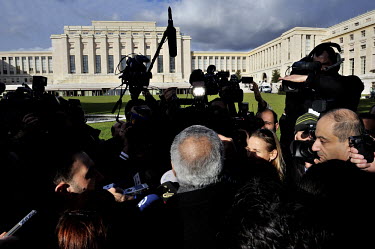 Syrian Minister of Information Omran al-Zoubi (middle, with back to camera) talks to the media in the park of the Palais des Nations during the Geneva II Syria talks. The Geneva II talks being held in...