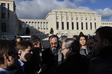 Syrian government Deputy Minister of Foreign Affairs Faisal Mekdad (with back to the camera) talks to the press outside the Palais des Nations in Geneva. The Geneva II talks being held in Montreux and...