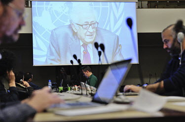Seen on a screen in an overflow press room, Joint Special Representative Lakhdar Brahimi at the Palais des Nations in Geneva, gives a press conference closing the third day of talks between representa...