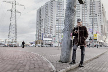 Dmitry Musolin Ph.D. Checking his phone near a bus station. He is a gay activist and Associate Professor of the Department of Forest Protection and Game Management & Director of the Department of Adva...