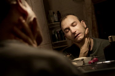 Gay activist Dmitry Musolin, rubs his chin after a shave at in his home in St. Petersburg. Dmitry Musolin Ph.D. is a gay activist and Associate Professor of the Department of Forest Protection and Gam...