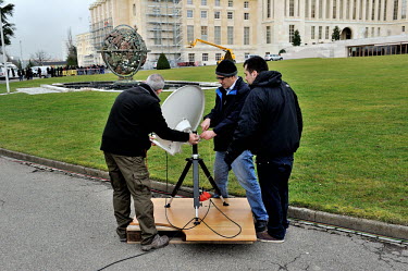 Press staff set up a satellite dish for TV broadcast on the grounds of the Palais des Nations on the first day of the second round of the Geneva II talks.  The Geneva II talks which started in Montreu...