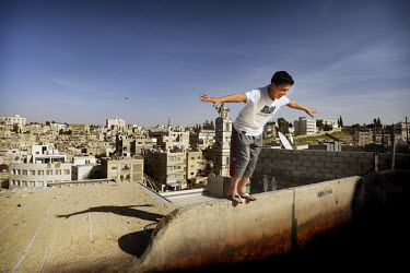 Adham plays on the roof of a building. He fled the war in Syria with his family and they now live in Amman. He comes from a middle class family and dreamt of becoming a pilot, a realistic ambition. Ho...