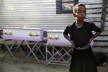 Azile Mali, cousin of Zandile Mali (3) and Yonelisa Mali (2), stands near the toddlers' coffins during the funeral service outside their shack in Diepsloot. Her two young cousins were raped and murder...