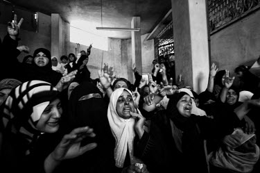 A crowd of women mourn at the funeral of a young Hamas militant killed during an Israeli raid.
