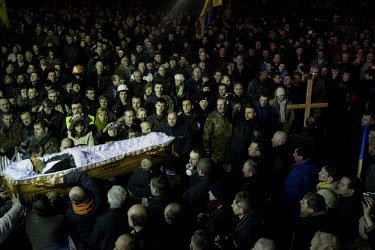 The coffin of a dead protester is held aloft at a funeral of one of the dozens of protesters who died in clashes between Police and protesters in Kiev. Protests against the government of President Vik...