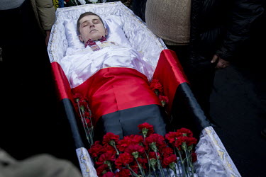 The body of one of the dozens of protesters who were killed in clashes between protesters and security forces in the third week of February 2014. The coffin is draped in black and red - the colours of...