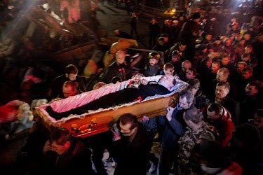 Men carry the coffin of 44 year old Tochin Roman, one of the dozens of protesters who died in clashes with police in Kiev on 20 February 2014, to the barricades in a final tribute. Protests against th...
