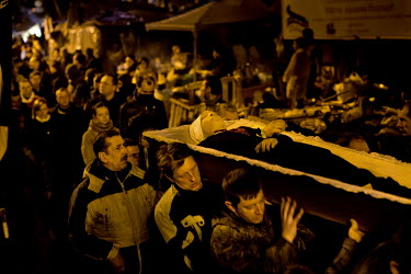 Men carry the coffin of one of the dozens of protesters who died in clashes with police in Kiev. Protests against the government of President Viktor Yanukovych were sparked on 21 November 2013 by the...
