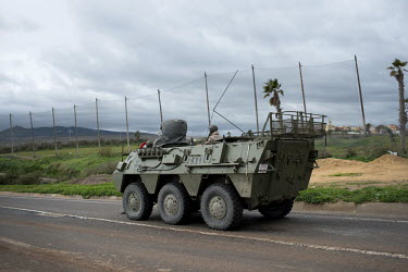 A Spanish military vehicle patrols the border between Morocco and Melilla. A Spanish exclave city on the north coast of Africa, Melilla is bounded by Morocco and the Mediterranean Sea. Many would-be m...