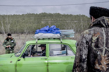 A man in a green car is stopped at a road block manned by pro Russian Serbian and Cossack militia on the road between Simferopol and Sevastopol.  Since the end of February, people in parts of eastern...