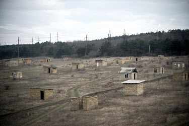 A typical collection of temporary Tatar settlements in a field near Simferopol. The sheds mark the place where Tatars have claimed land that has no official ownership. They build small huts to claim t...